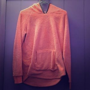 A pink jacket with gray around the hood